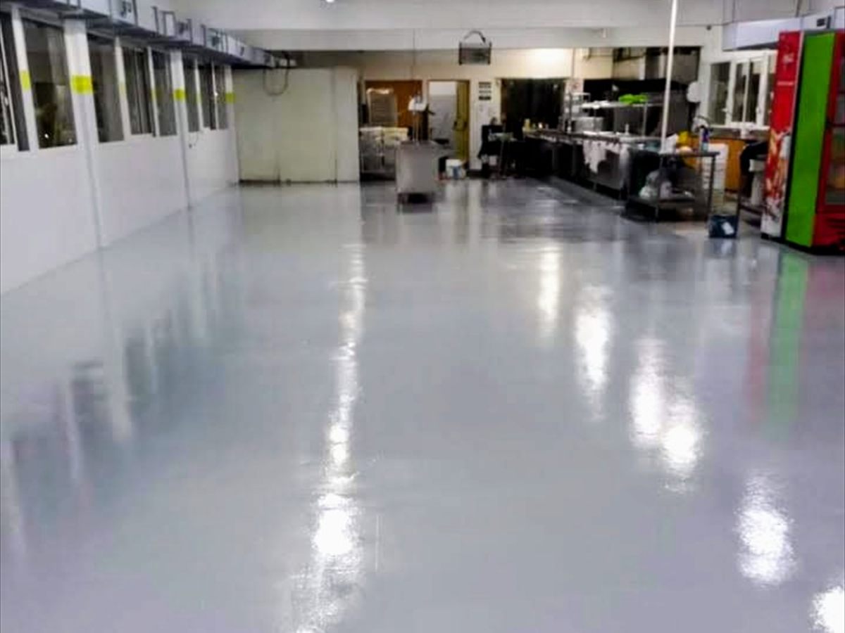 Piso epoxi gris terminado en la cocina industrial de un comercio gastronómico